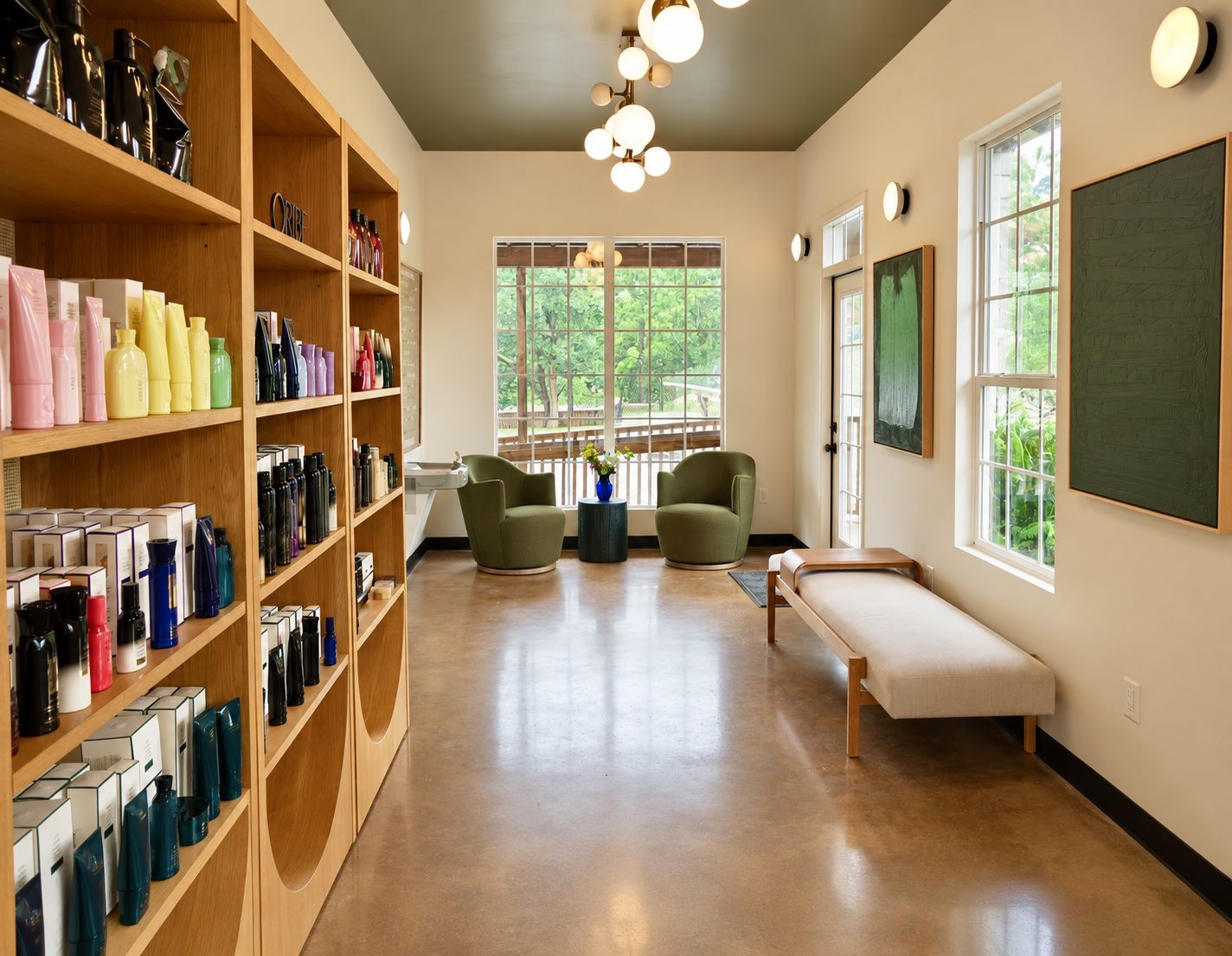 The lounge, with green swivel chairs, an Oribe retail wall, and garden windows